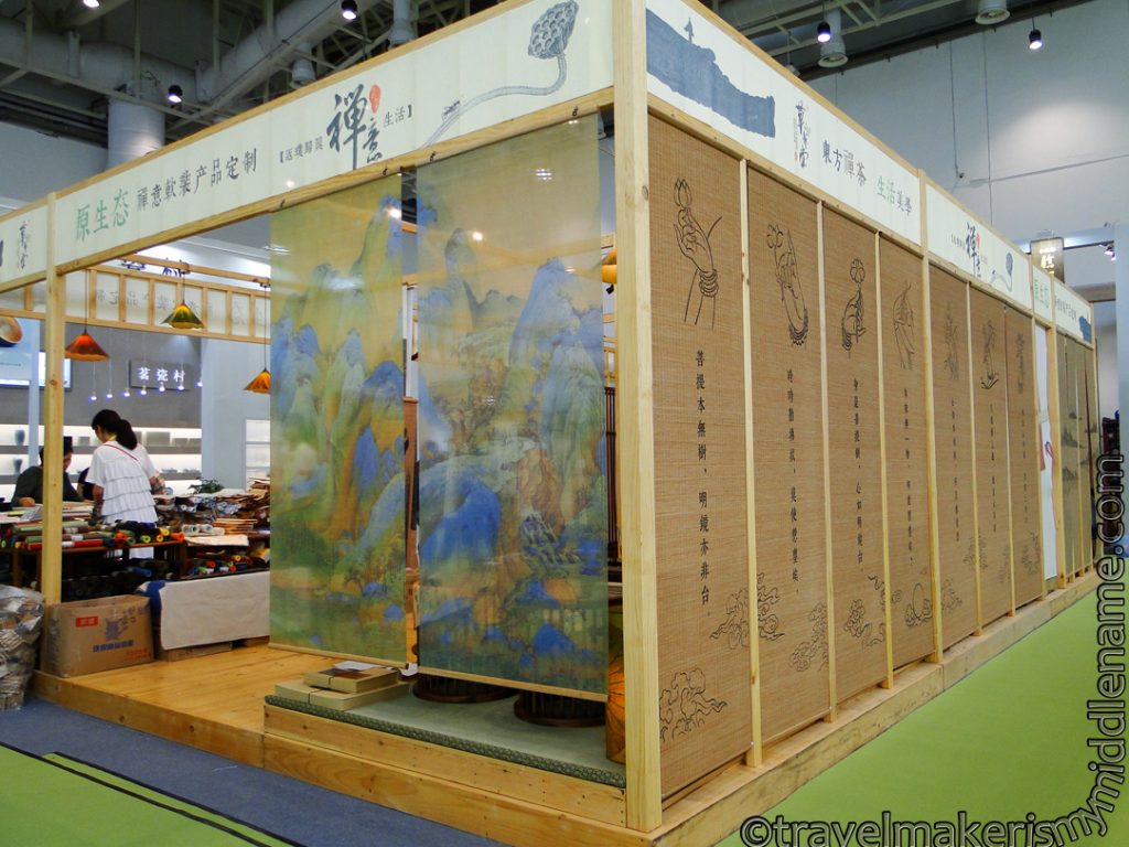 A stall with artwork hanging on the side at the Spring Xiamen Tea Fair.