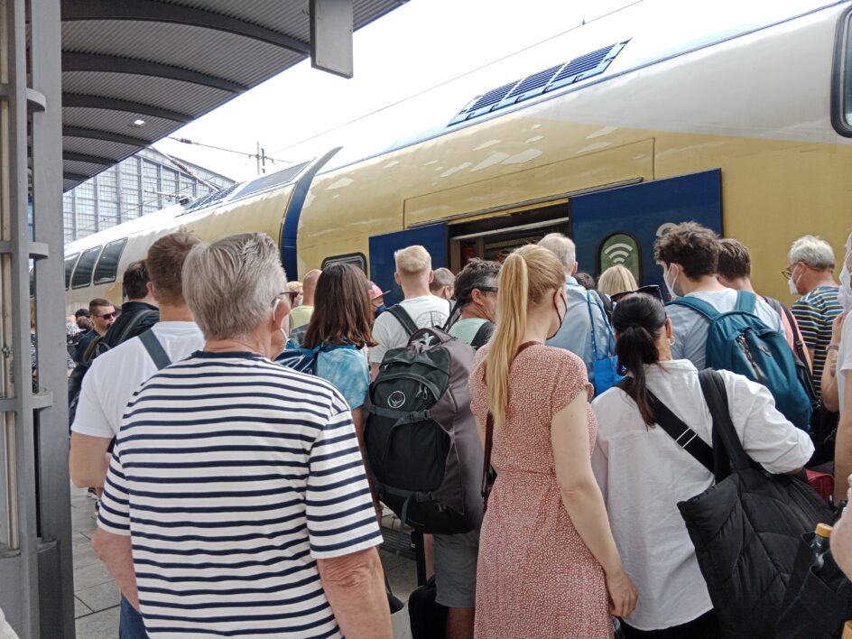 People waiting to get on a train
