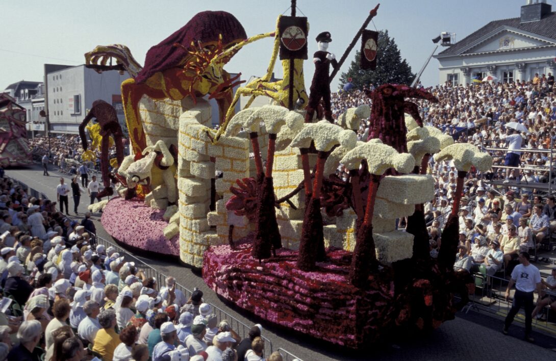 A large parade float that resembles a castle wall.