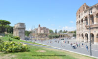 Wide shot of the Colosseum on the right, Velian Hill in the center, and Arch of Constantine on the left in Rome, Italy.
