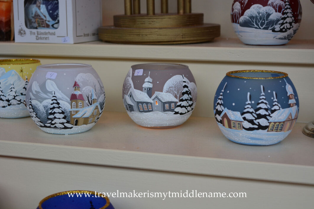 Hand painted round glass candle holders depicting snow covered towns and trees