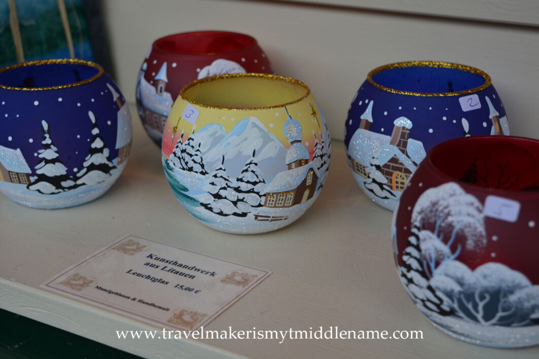 Hand painted round glass candle holders depicting snow covered towns and trees