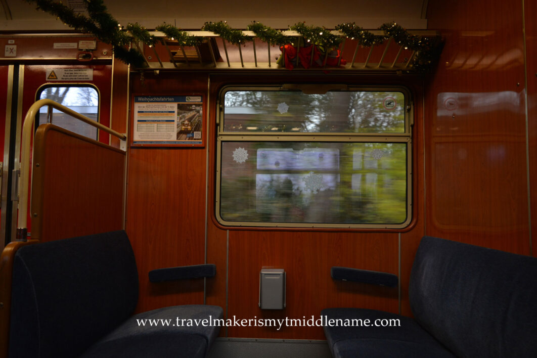 Inside the Hamburg Christmas Train, blue plush seats in first lass