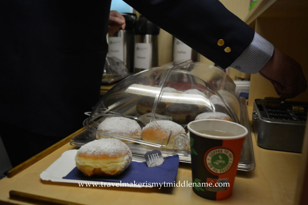 The conductor serving jam donuts and tea in the vintage Hamburg Christmas train