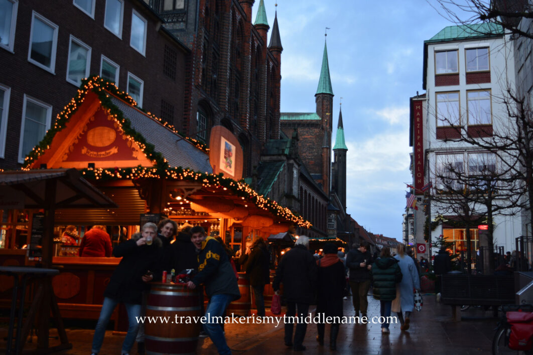 3 guys posing for the camera at a Christmas market in Lübeck