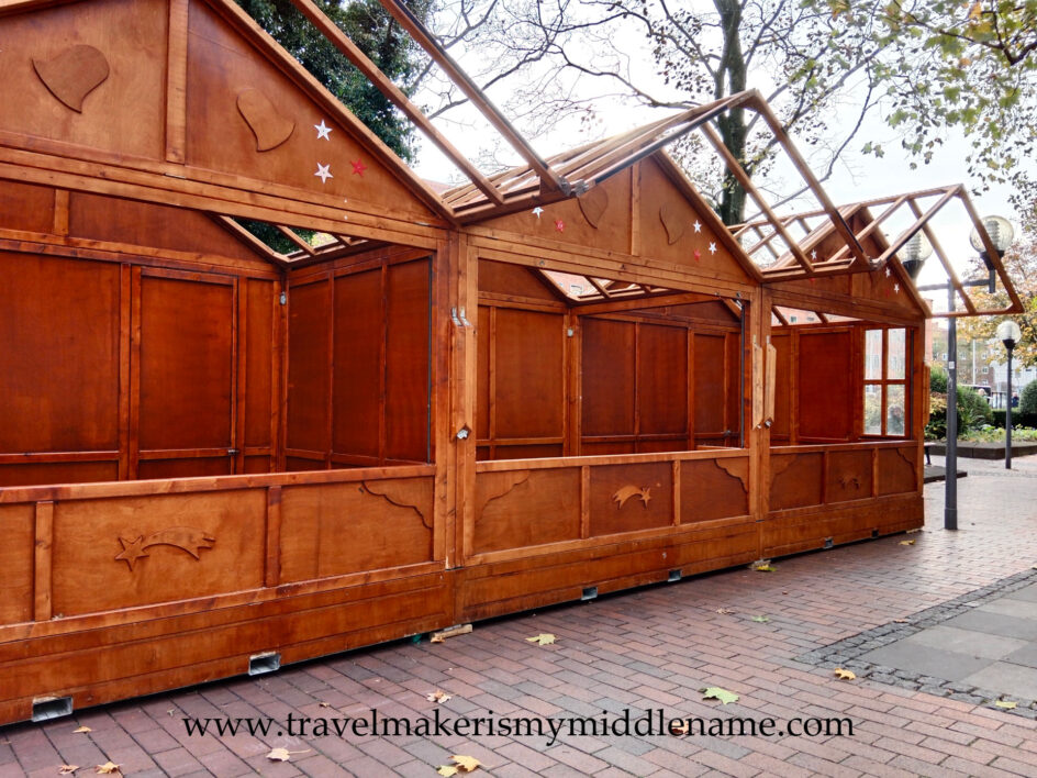 Empty Christmas market huts being set up during the day