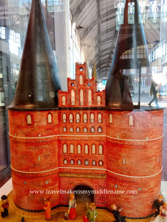 Marzipan model of the Holstentor with miniature people in front