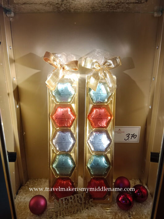 Hexagonal Christmas chocolate wrapped in light blue, red, silver and teal foil from the Niederegger shop in Lübeck